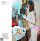 A woman in a bikini standing in front of a blender.